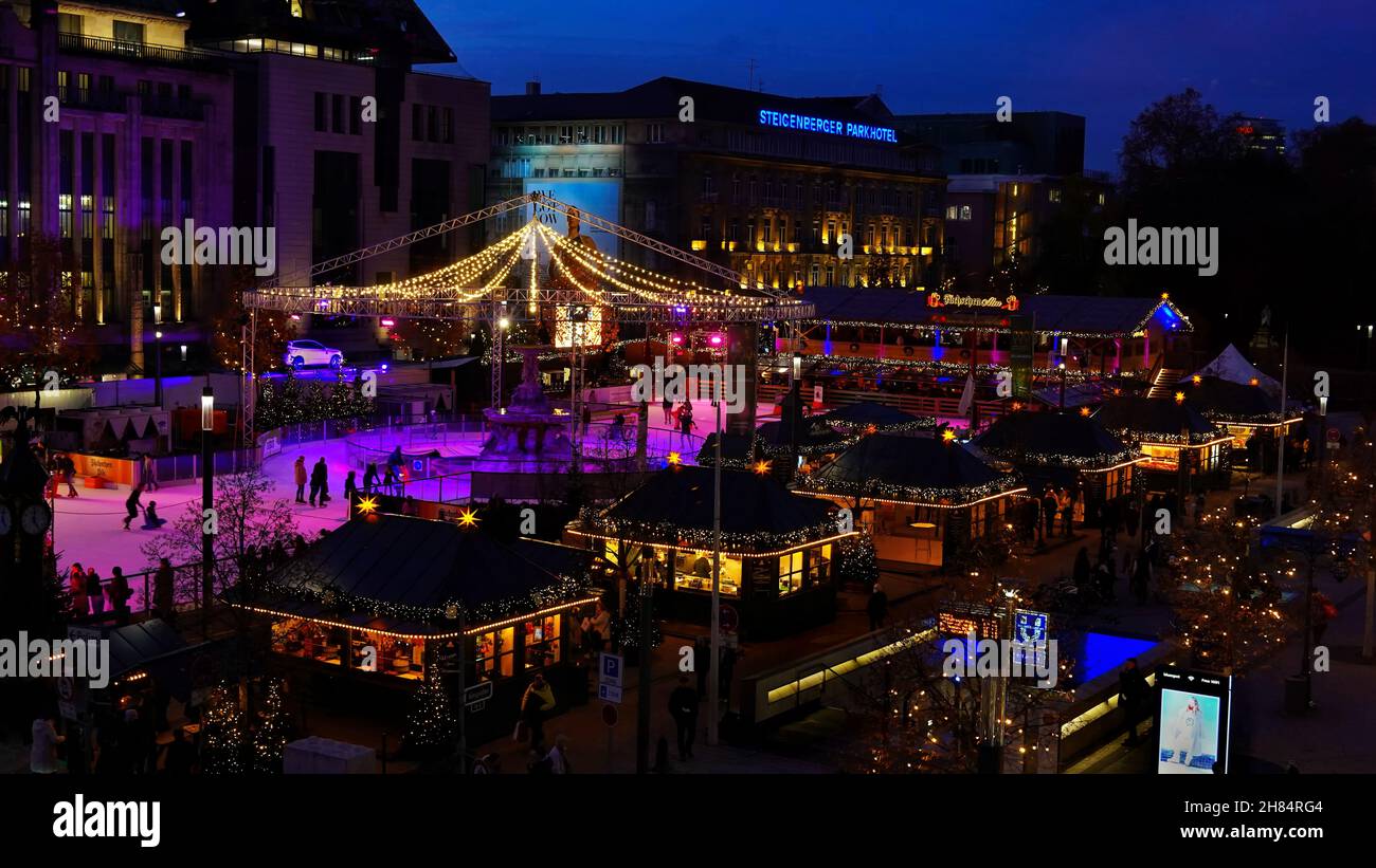 Aerial night view of the illuminated Düsseldorf Christmas market 2021 in downtown Düsseldorf/Germany with ice skating rink. Stock Photo