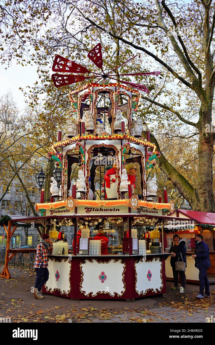 Christmas booth with typical German vintage pyramid at the Christmas market 2021 on Königsallee in Düsseldorf/Germany. Stock Photo