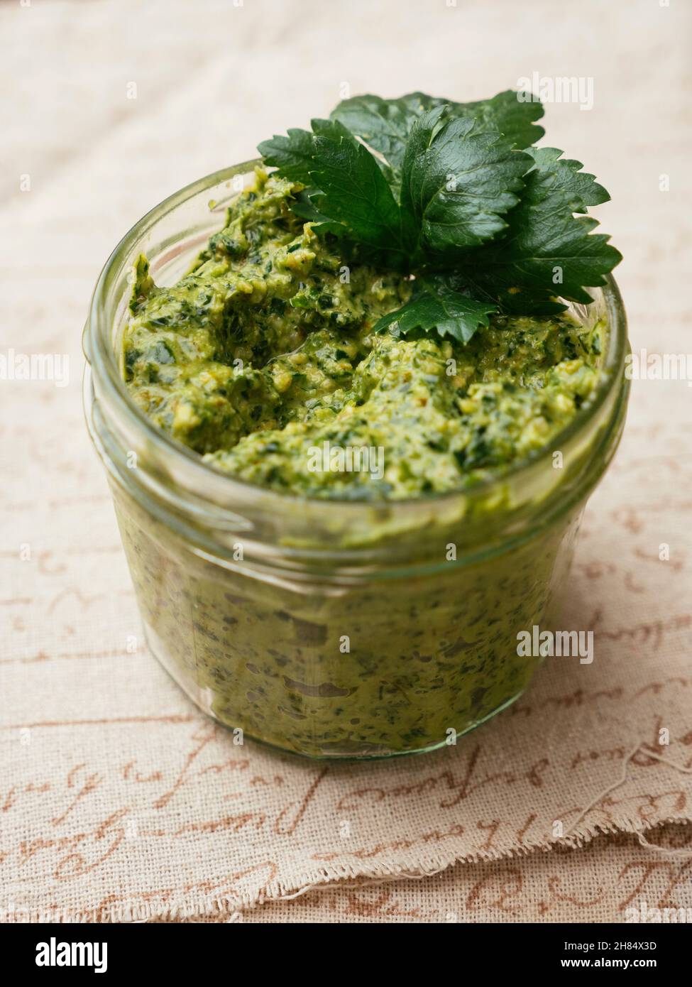 Home made vegan celery leaf pesto in a jar. Stock Photo