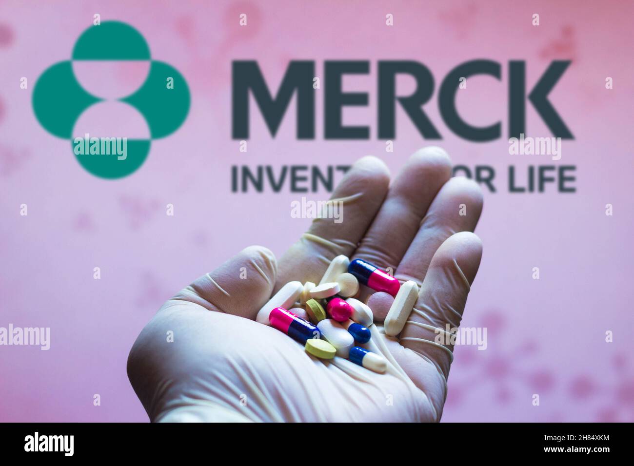 Brazil. 27th Nov, 2021. In this photo illustration, a Merck Sharp and Dohme logo is seen on a screen and a hand holding pills. Credit: SOPA Images Limited/Alamy Live News Stock Photo