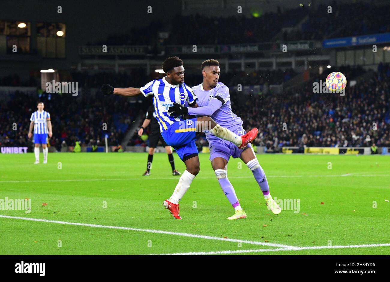 Brighton, UK. 27th Nov, 2021. Tariq Lamptey of Brighton and Hove Albion manages to cross the ball into the box under pressure from Junior Firpo of Leeds United during the Premier League match between Brighton & Hove Albion and Leeds United at The Amex on November 27th 2021 in Brighton, England. (Photo by Jeff Mood/phcimages.com) Credit: PHC Images/Alamy Live News Stock Photo