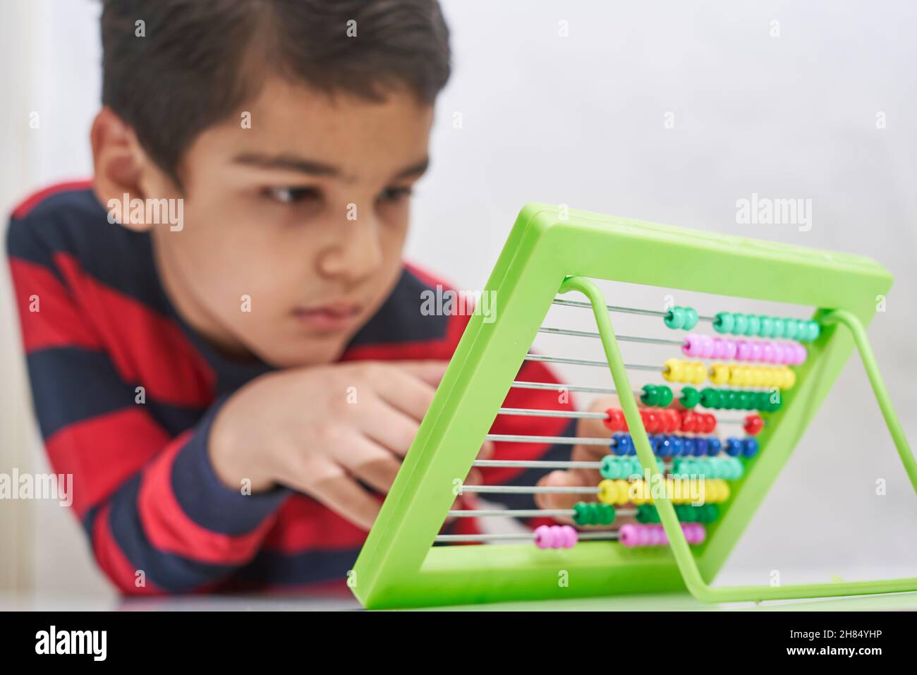 Schoolboy do mental math. Mental mathematics. 8 years old multiracial ...