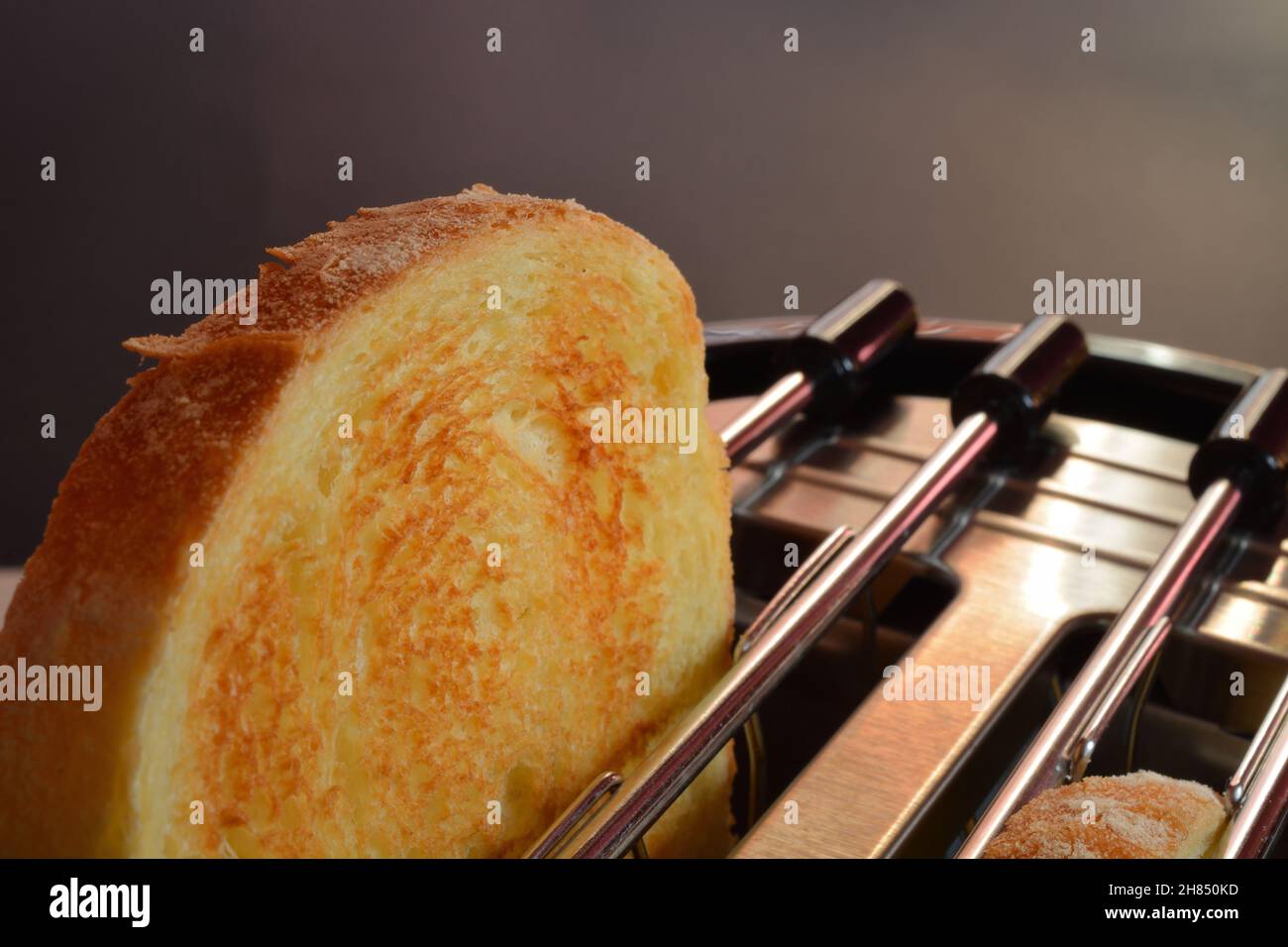 Toasted bread. A slice of toasted bread jumping out the toaster Stock