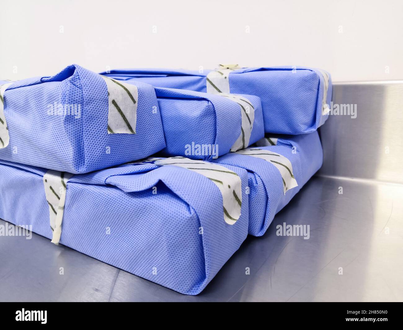 Closeup Image Of Sterilized Blue Wrapped Telescope Packages Stack On Top. Selective Focus Stock Photo