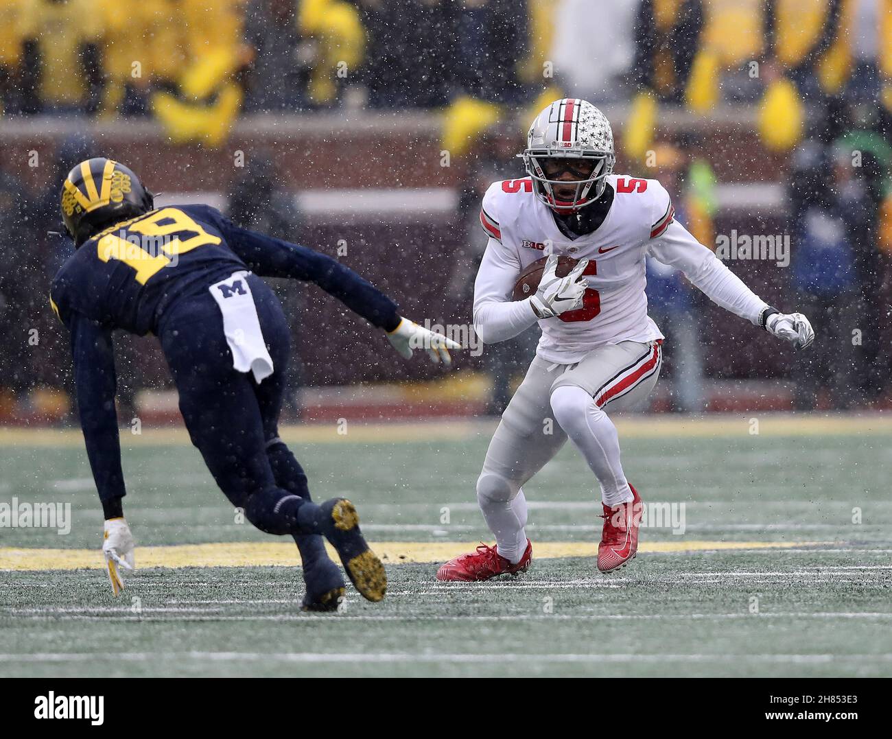 Ann Arbor, United States. 27th Nov, 2021. Ohio State Buckeyes Garrett Wilson (5) makes a move on Michigan Wolverine Rod Moore (19) in the first half in Ann Arbor, Michigan on Saturday, November 27, 2021. Photo by Aaron Josefczyk/UPI Credit: UPI/Alamy Live News Stock Photo