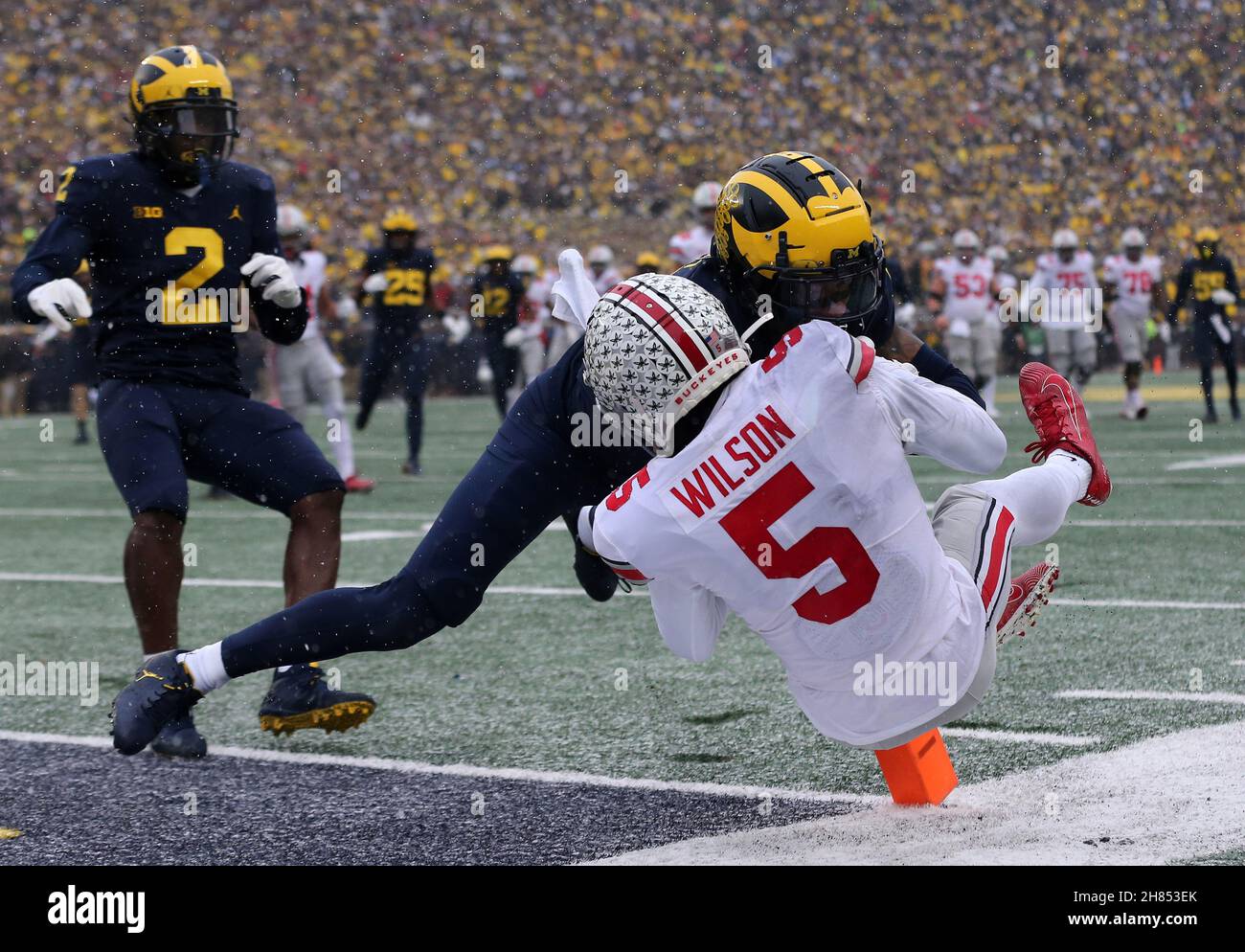 Ann Arbor, United States. 27th Nov, 2021. Ohio State Buckeyes Garrett Wilson (5) is knocked into the endzone for a touchdown by Michigan Wolverine Vincent Gray in the first half in Ann Arbor, Michigan on Saturday, November 27, 2021. Photo by Aaron Josefczyk/UPI Credit: UPI/Alamy Live News Stock Photo