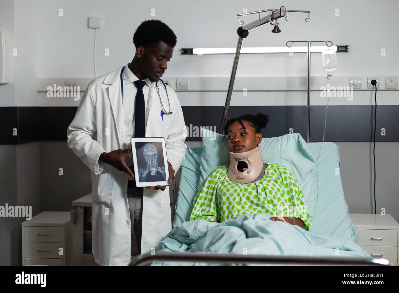 African american radiologist man holding tablet discussing bones