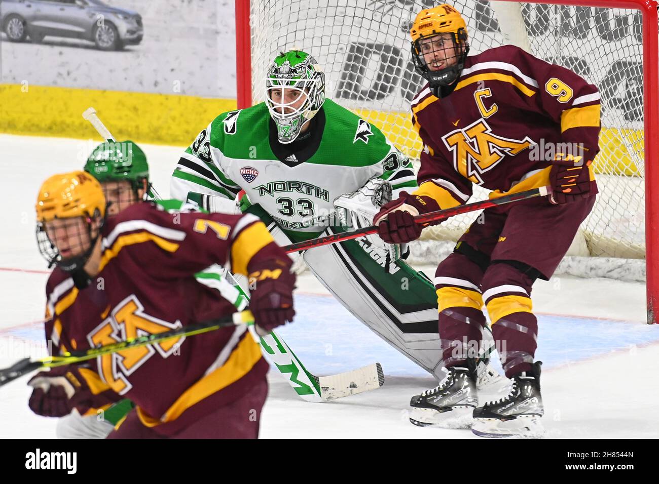 November 26, 2021 Minnesota Gophers forward Sammy Walker (9) waits for the puck in front of North Dakota Fighting Hawks goaltender Zach Driscoll (33) during a NCAA men's hockey game between the Minnesota Gophers and the University of North Dakota Fighting Hawks at Ralph Engelstad Arena in Grand Forks, ND. Minnesota won 5-1. By Russell Hons/CSM Stock Photo