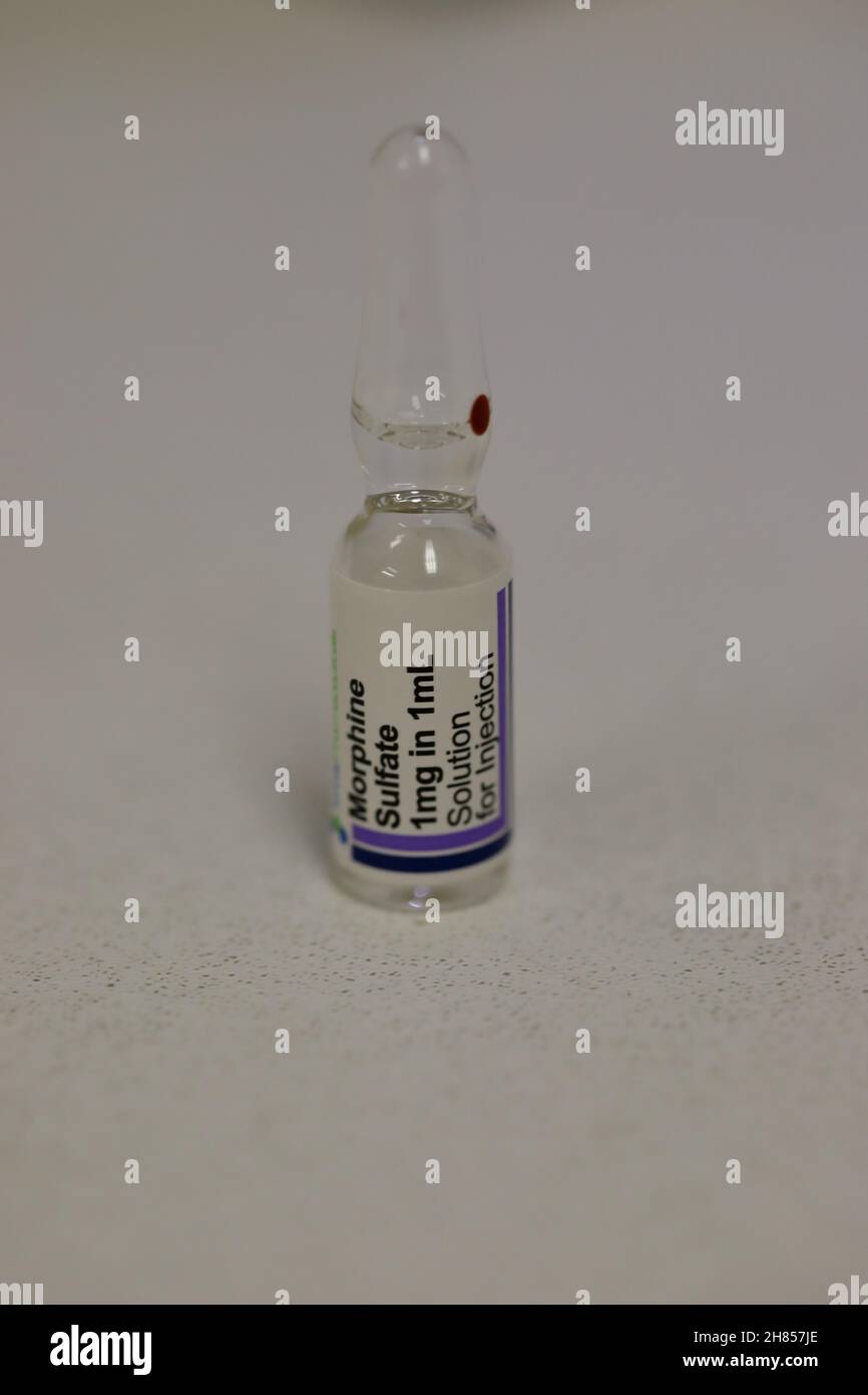 a glass ampoule of morphine sulphate solution containing 1mg in 1ml preservative free suitable for intrathecal (Spinal epidural) use Stock Photo
