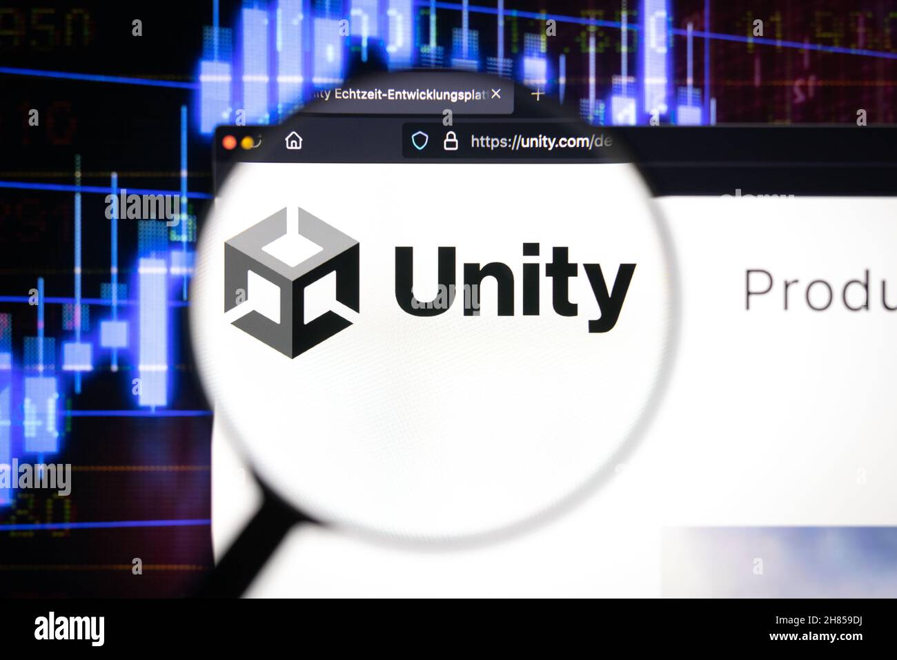 Unity game engine company logo on a website, seen on a computer screen through a magnifying glass. Stock Photo