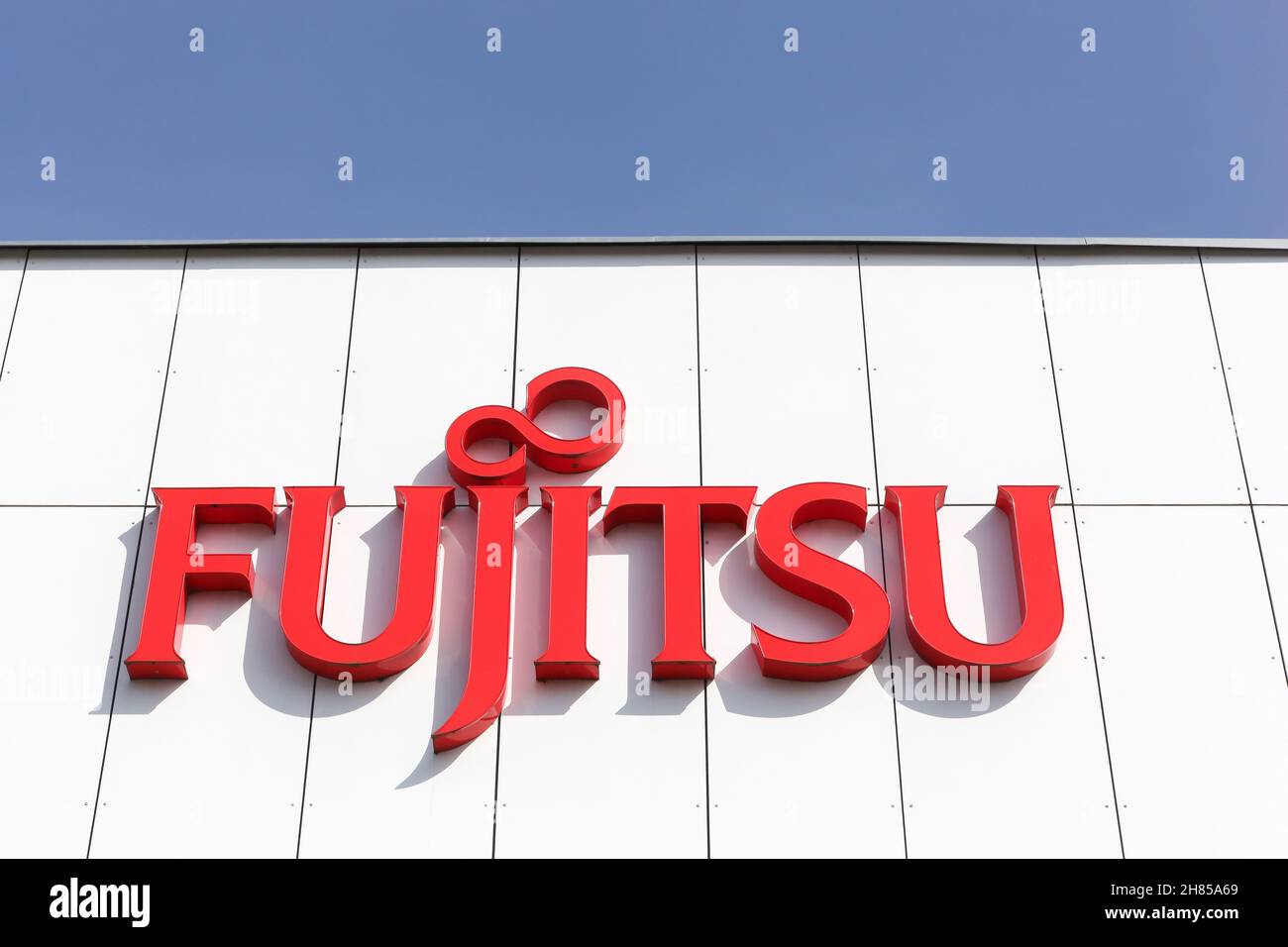 Holme, Denmark - April 8, 2018: Fujitsu logo on a wall. Fujitsu is a Japanese multinational information technology equipment Stock Photo