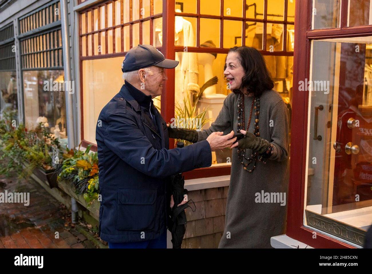 Nantucket, United States Of America. 26th Nov, 2021. Nantucket, United States of America. 26 November, 2021. U.S President Joe Biden, left, greets a small business owner during Black Friday sales day November 26, 2021 in Nantucket, Massachusetts. Biden spend the day visiting local shops and attending the annual village Christmas tree lighting ceremony with his family. Credit: Adam Schultz/White House Photo/Alamy Live News Stock Photo