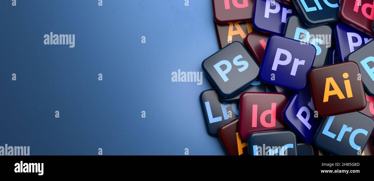 Logos of the major parts of the Creative Cloud Apps Suite (Illustrator, Photoshop, InDesign, Lightroom Classic, Premiere Pro) on a heap on a table. Co Stock Photo