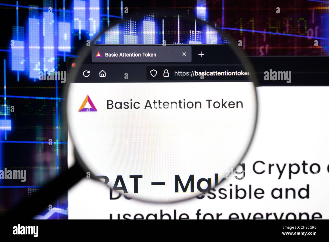 Basic Attention Token company logo on a website, seen on a computer screen through a magnifying glass. Stock Photo