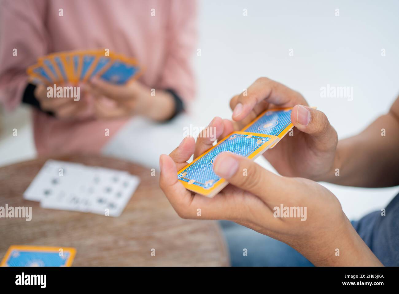 Close up of a hand shuffling cards while playing cards Stock Photo Alamy