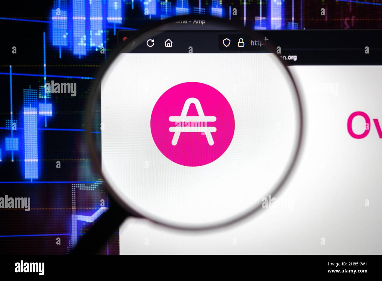 Amp company logo on a website, seen on a computer screen through a magnifying glass. Stock Photo