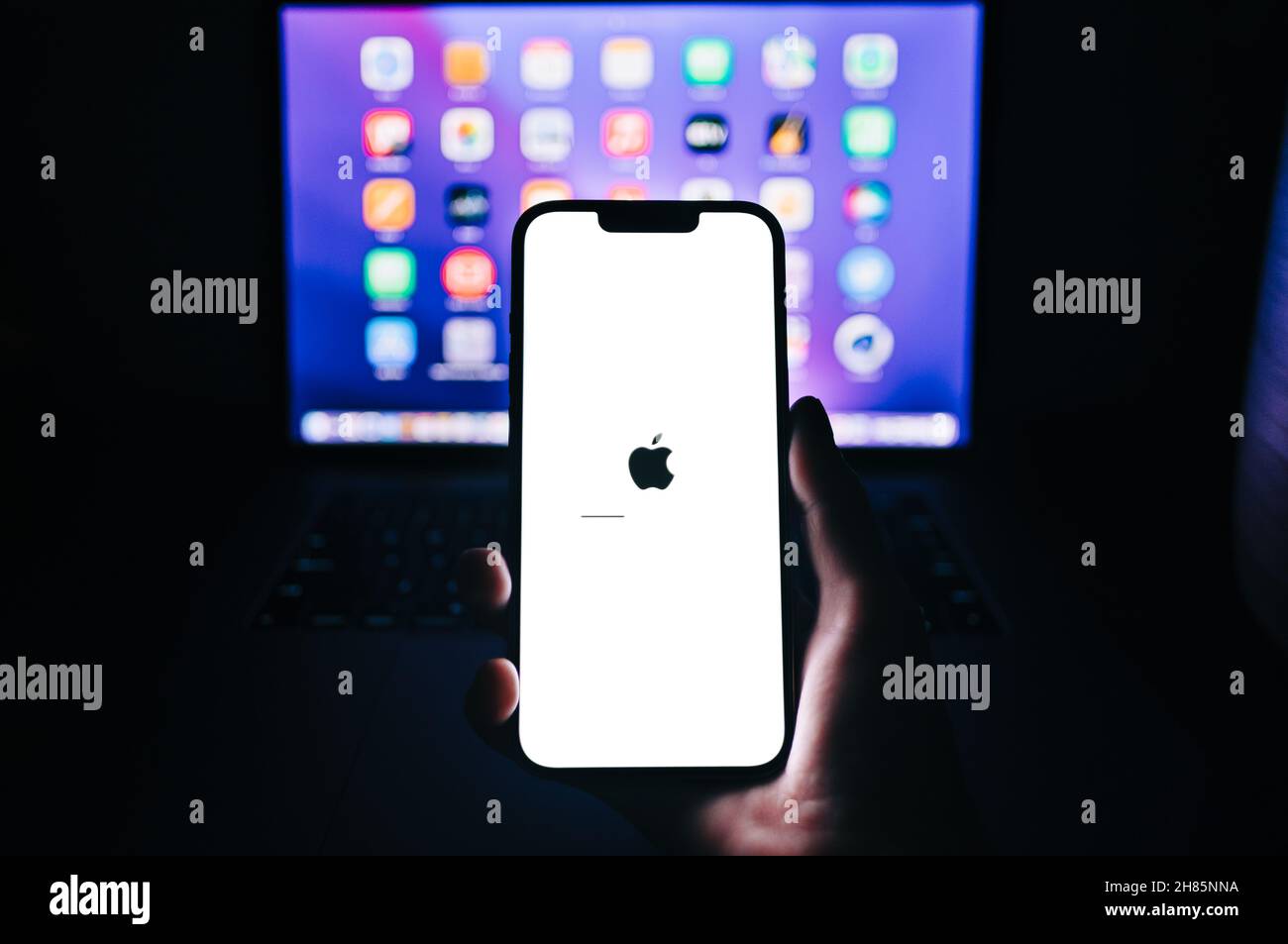 Hand hold the iPhone 13 pro with iOS firmware update process on the ...
