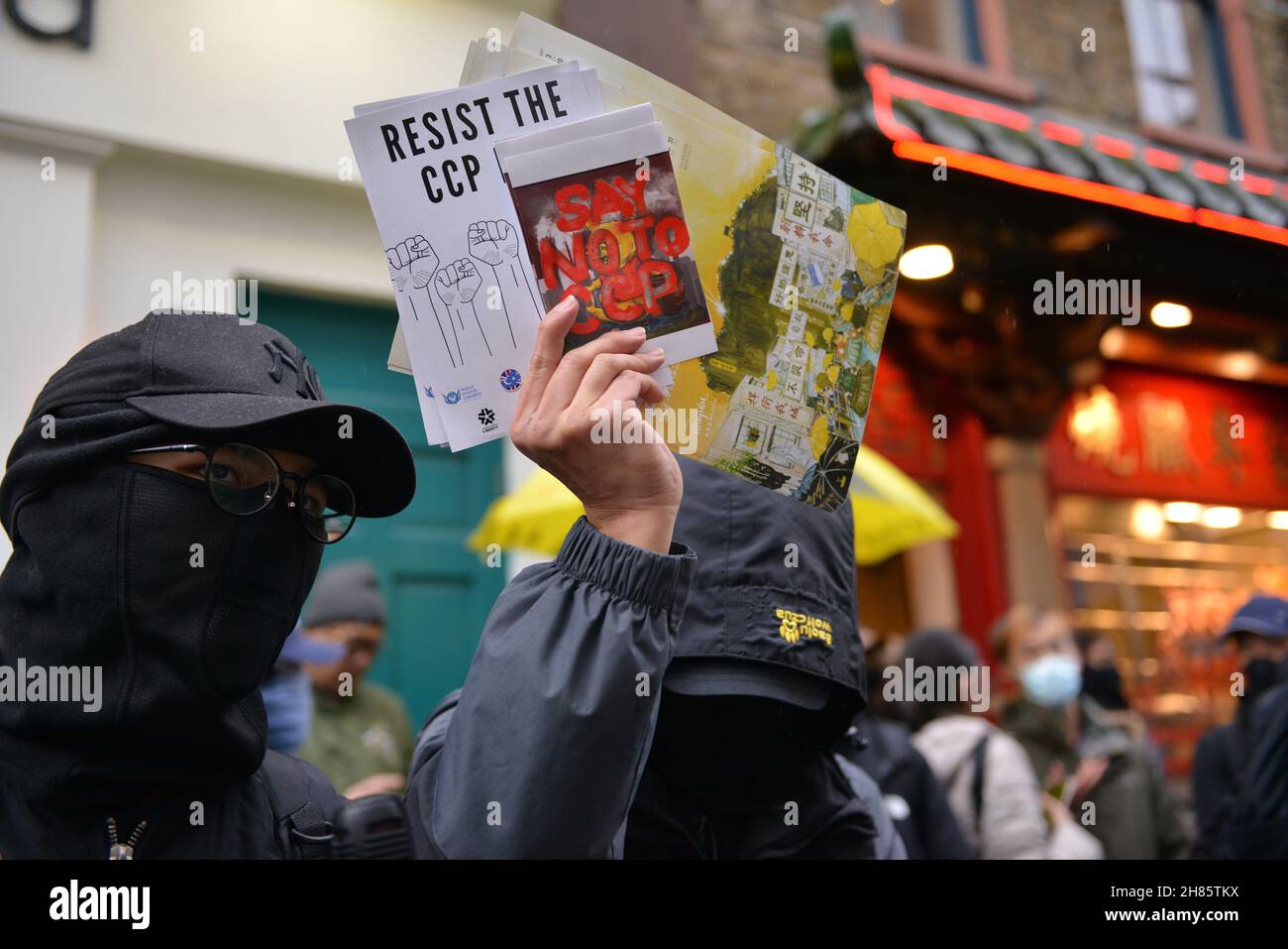 London, UK. 27th Nov, 2021. A pro Hong Kong democracy and anti CCP protester holds anti ccp placards during the counter protest. Dozens of pro democracy, pro Hong Kong independence and anti CCP (Chinese Communist Party) protesters hosted a counter protest against the Stop Anti-Asian Hate rally 'against the new cold war' organized by the Chinese associations in the UK, in London's Chinatown. Credit: SOPA Images Limited/Alamy Live News Stock Photo