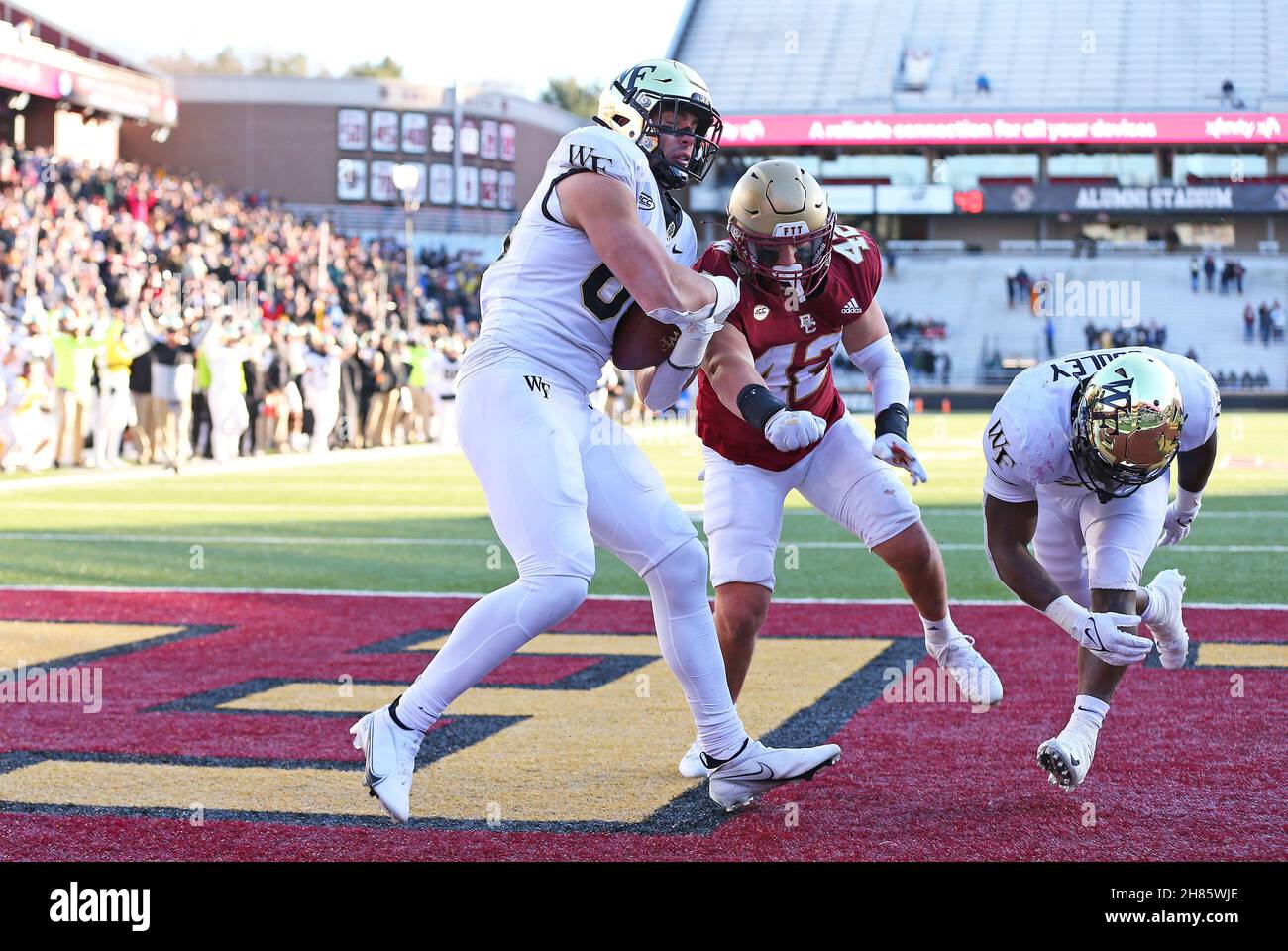 Alumni Stadium. 27th Nov, 2021. MA, USA; Wake Forest Demon Deacons tight  end Blake Whiteheart (85) catches a touchdown pass as Boston College Eagles  linebacker Vinny DePalma (42) attempts to punch the