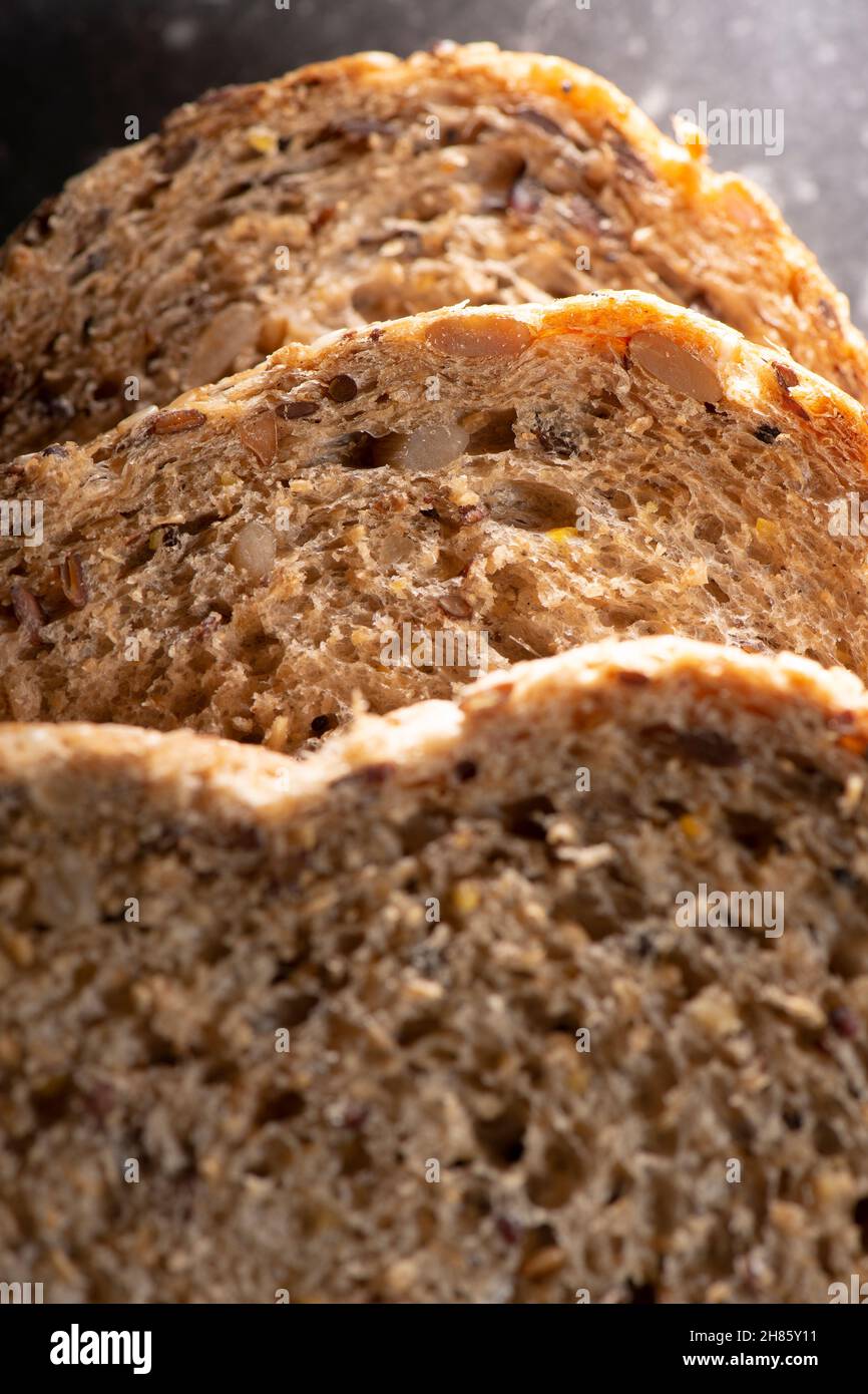 Detailed close up of high fibre low GI seven seeds and grain bread in low key lighting Stock