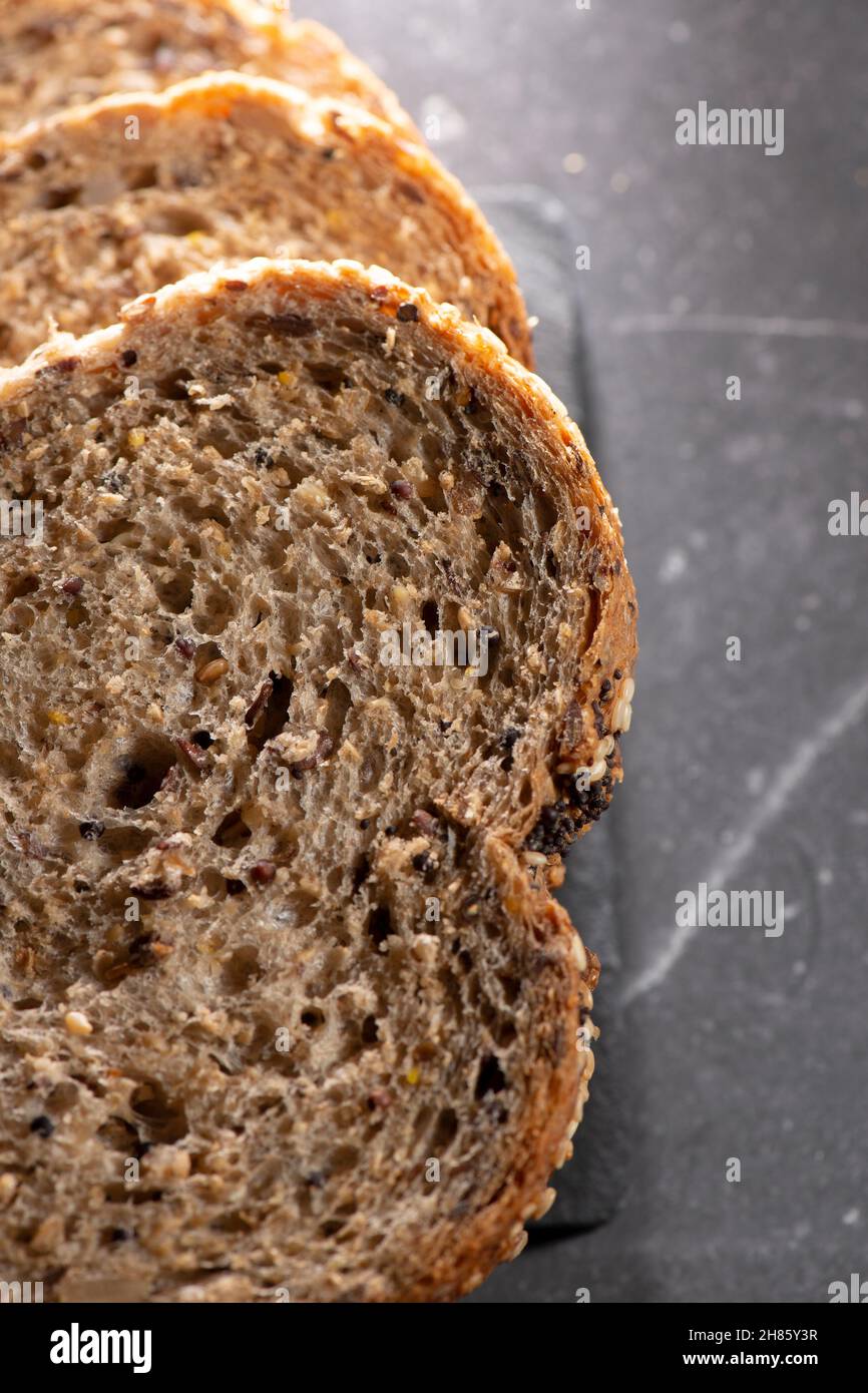 Detailed close up of high fibre low GI seven seeds and grain bread in low key lighting Stock