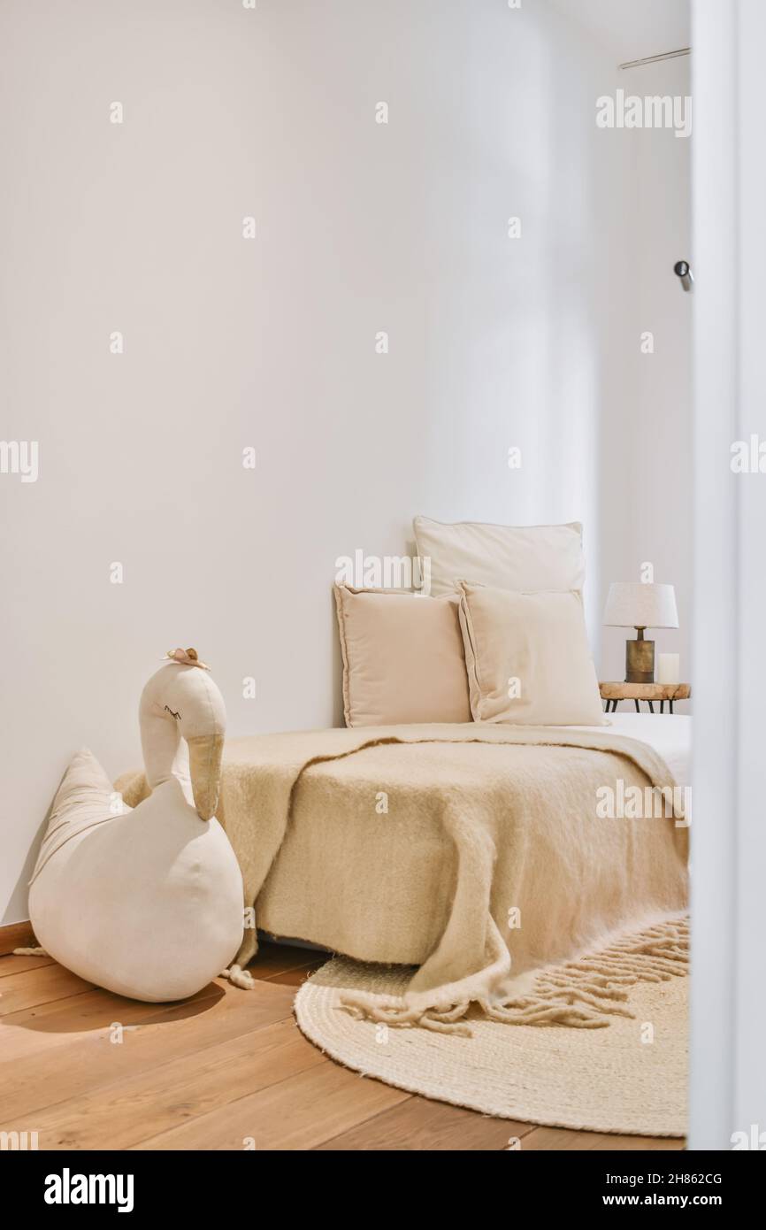 Small bedroom with a single bed in a minimalist style Stock Photo - Alamy