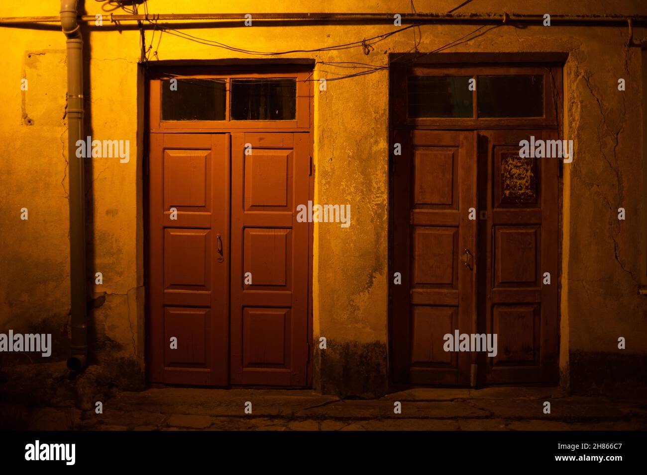 Two wooden doors at night on the street Stock Photo Alamy