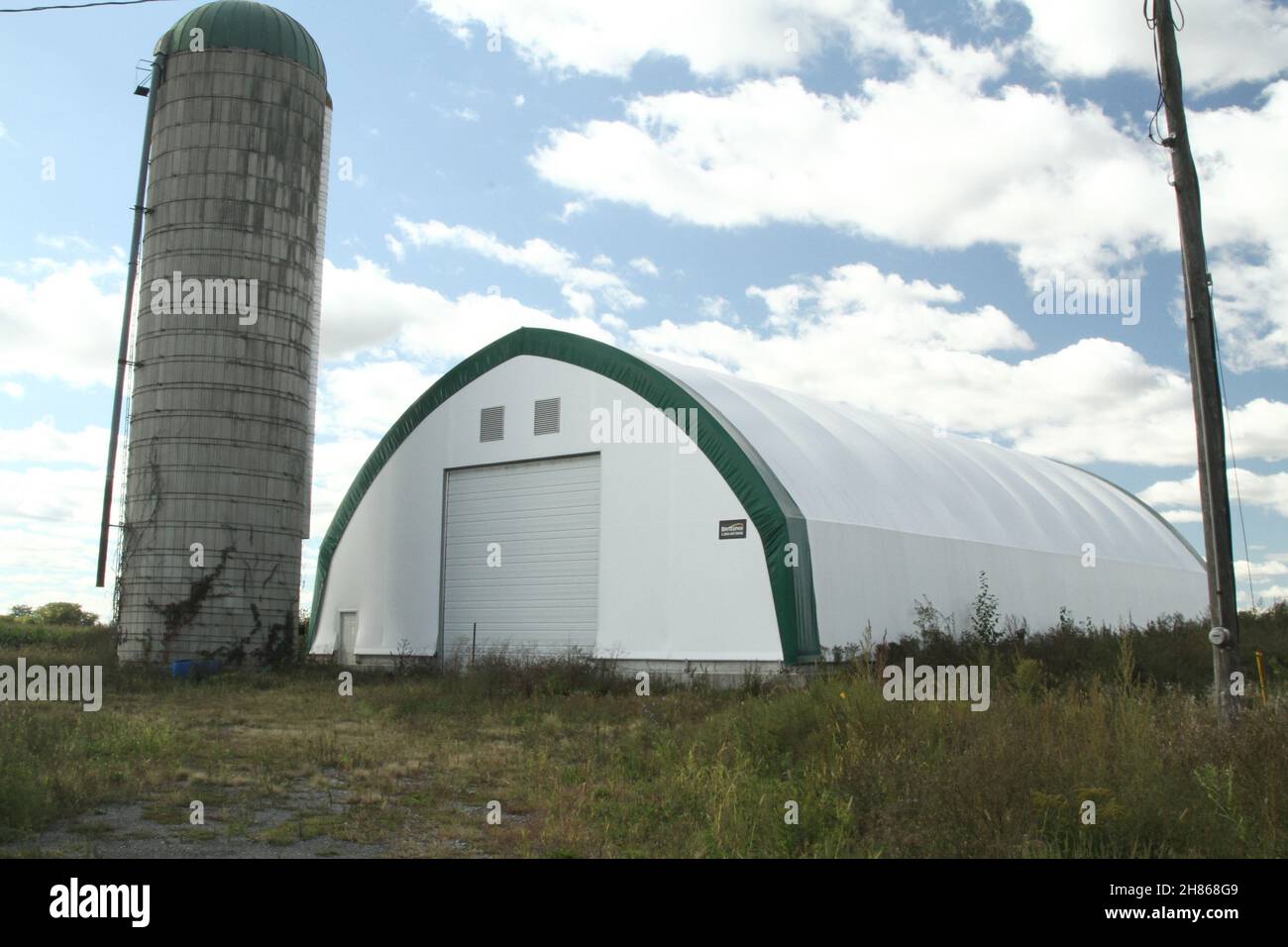 Hay storage and equipment building with silo Stock Photo