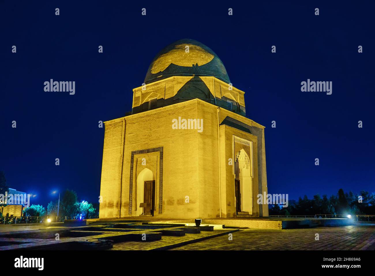 Rukhabad mausoleum illuminated at night, Samarkand, Uzbekistan. The building looks mystical and mysterious Stock Photo