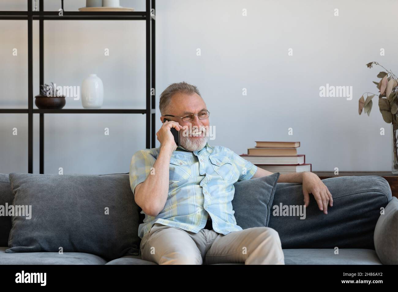 Happy elder grandfather talking on mobile phone Stock Photo