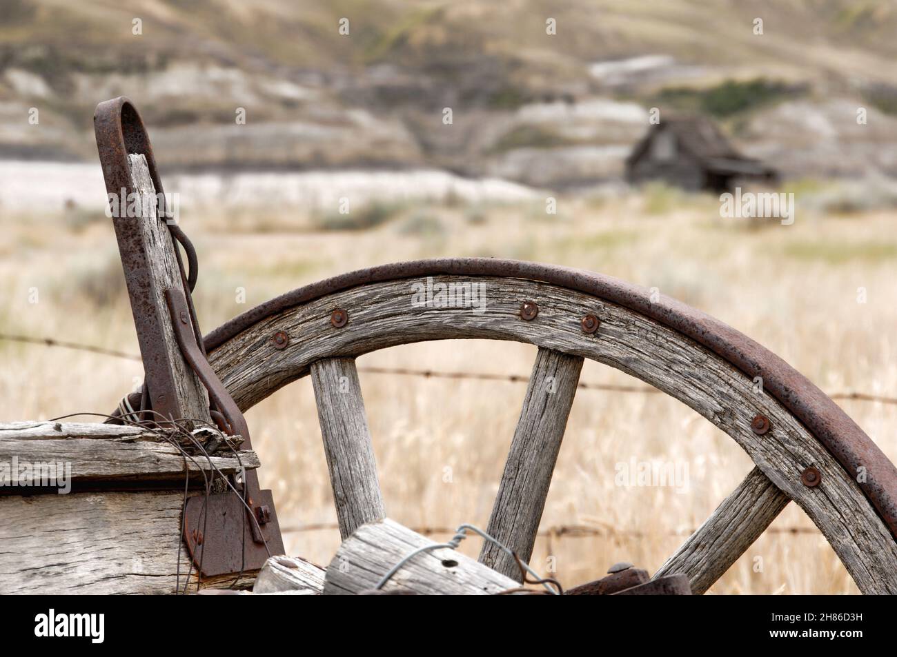 Old western wagon with farmhouse in background. Stock Photo