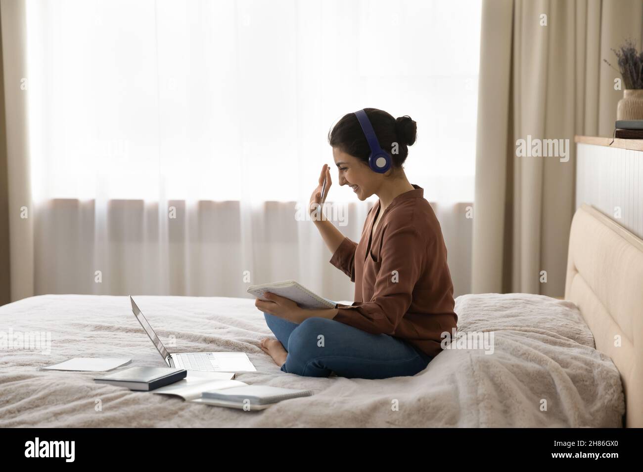 Happy young indian woman starting video call. Stock Photo