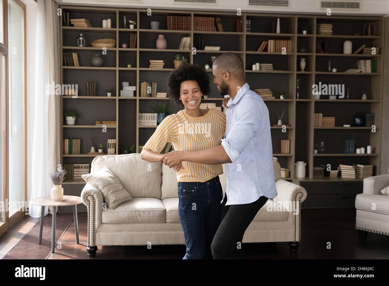 Excited millennial African American couple dancing together Stock Photo ...