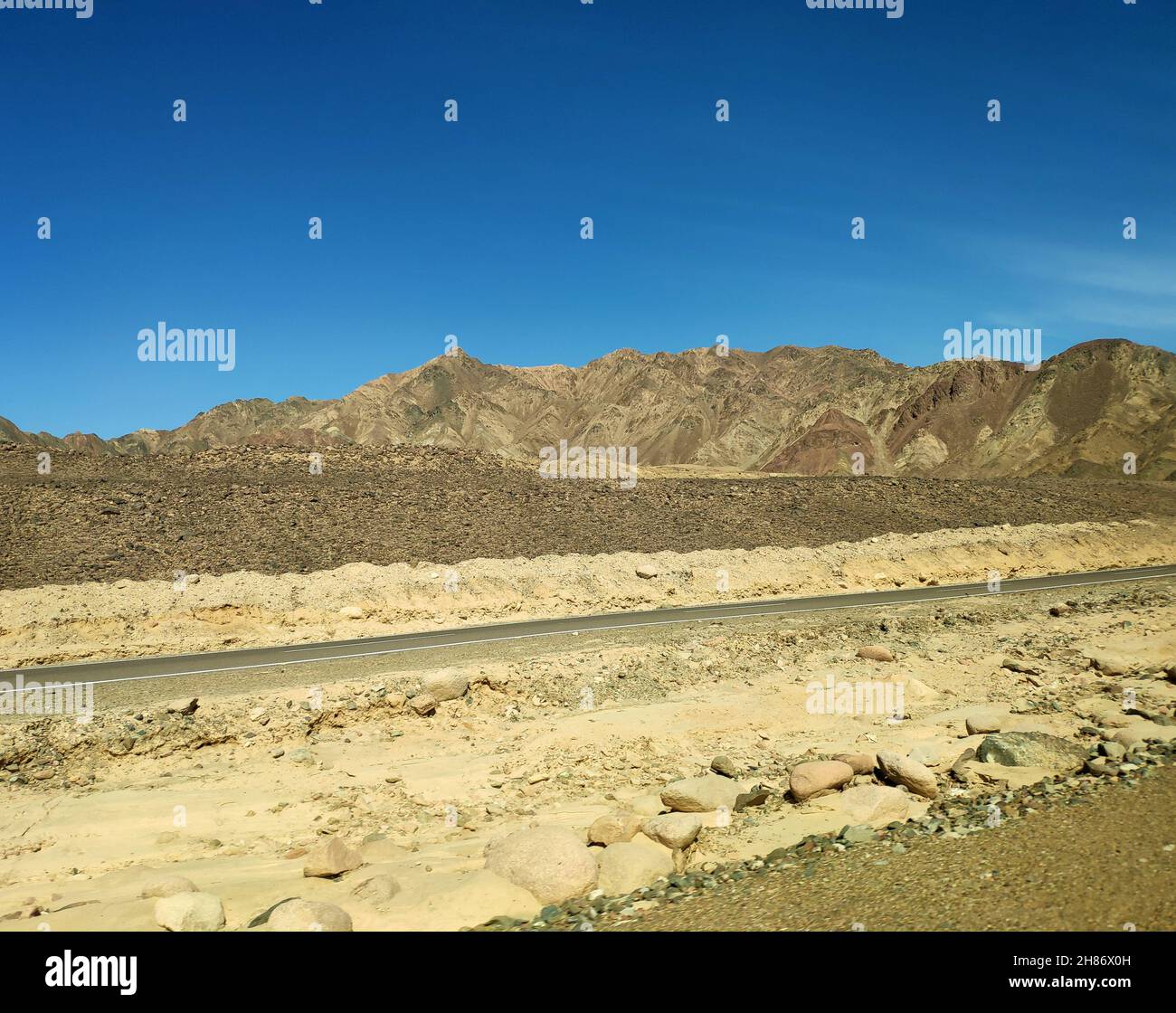 Road in the Sinai desert, picturesque background with mountains and hills, desert landscape wallpaper Stock Photo