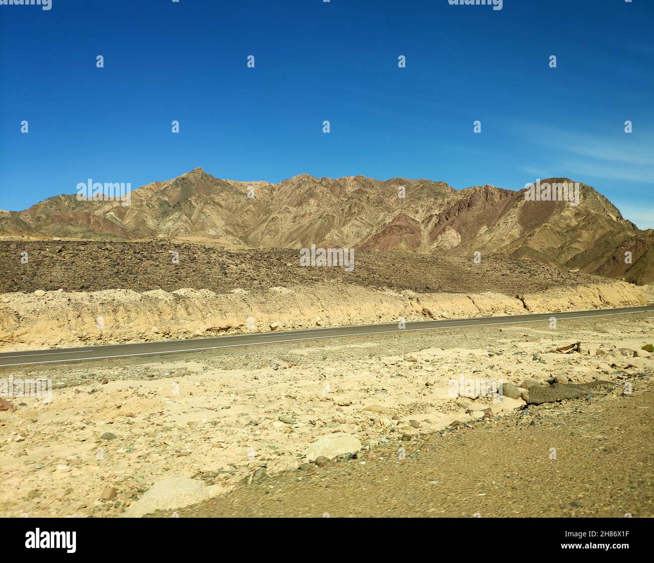 Road in the Sinai desert, picturesque background with mountains and hills, desert landscape wallpaper Stock Photo