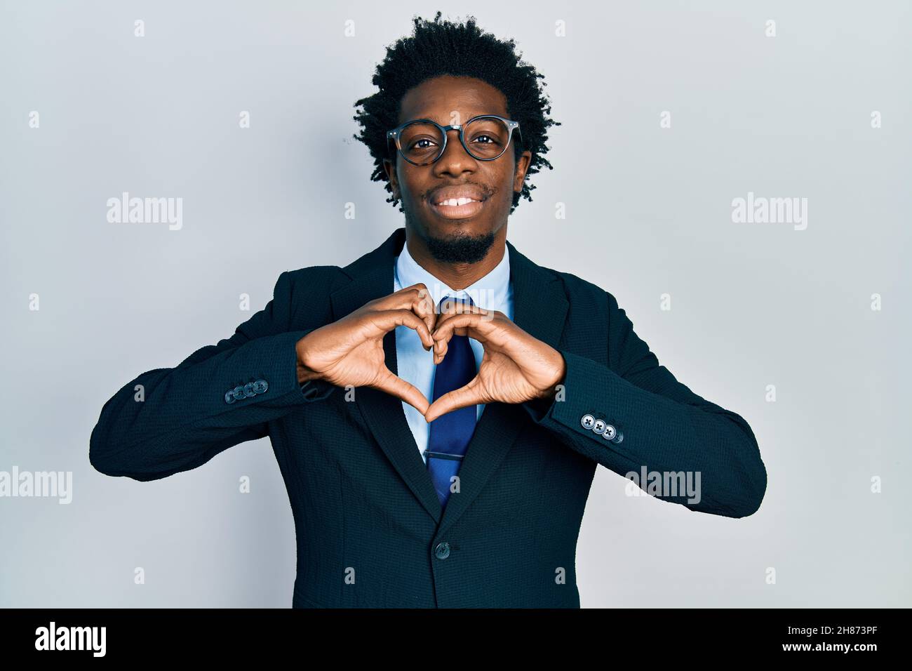 Young african american man wearing business suit smiling in love ...