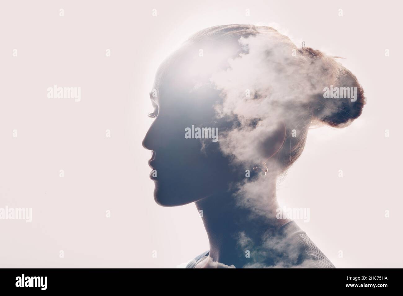 Psychology and caucasian woman mental health concept. Multiple exposure clouds and sun on female head silhouette. Stock Photo