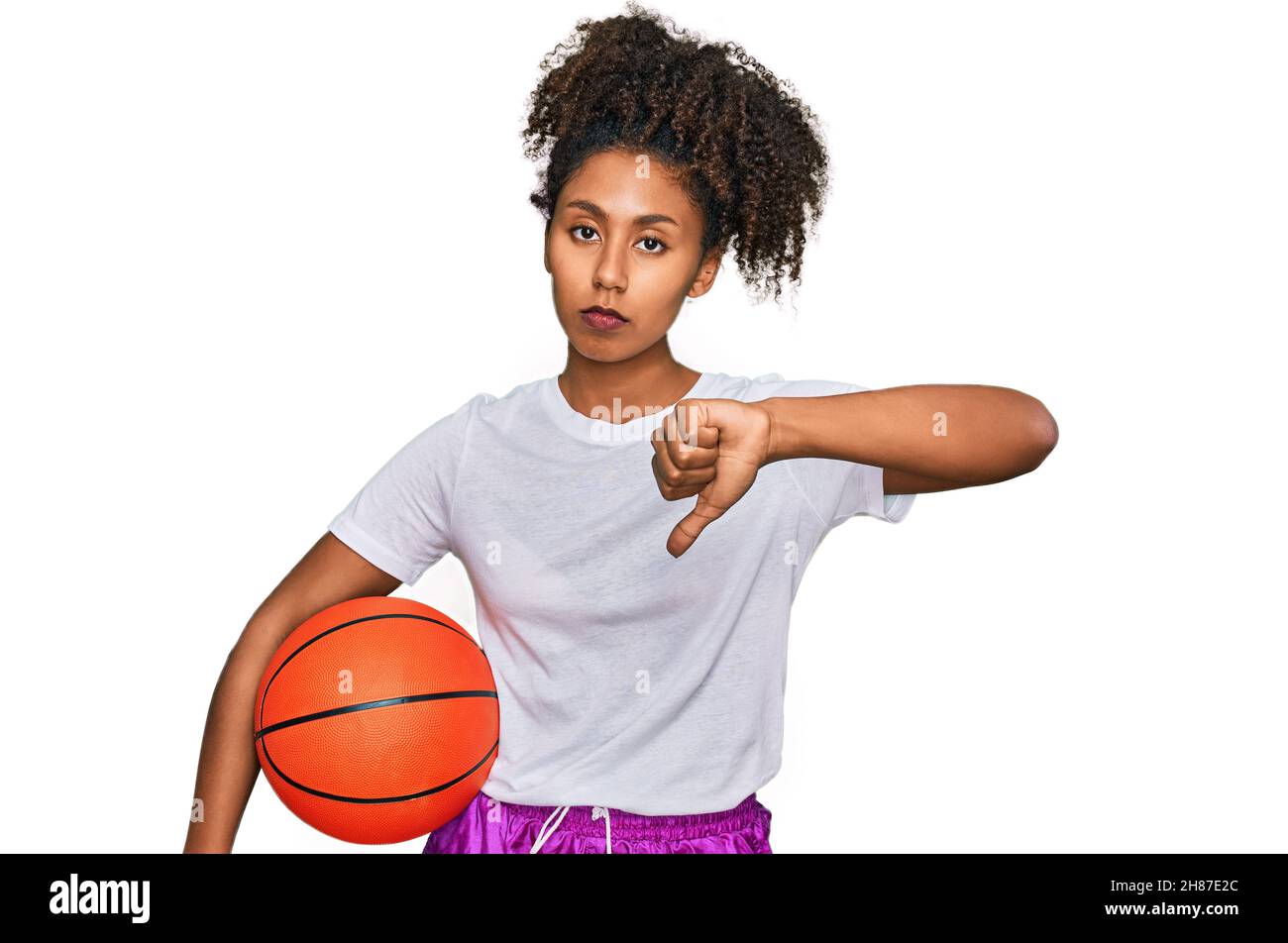 Young african american girl playing baseball holding bat and ball with