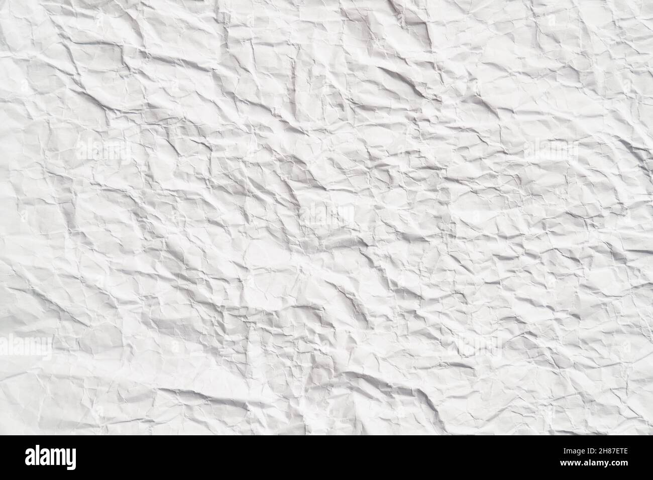 White crumpled paper texture with wrinkles. Damaged and torn sheet