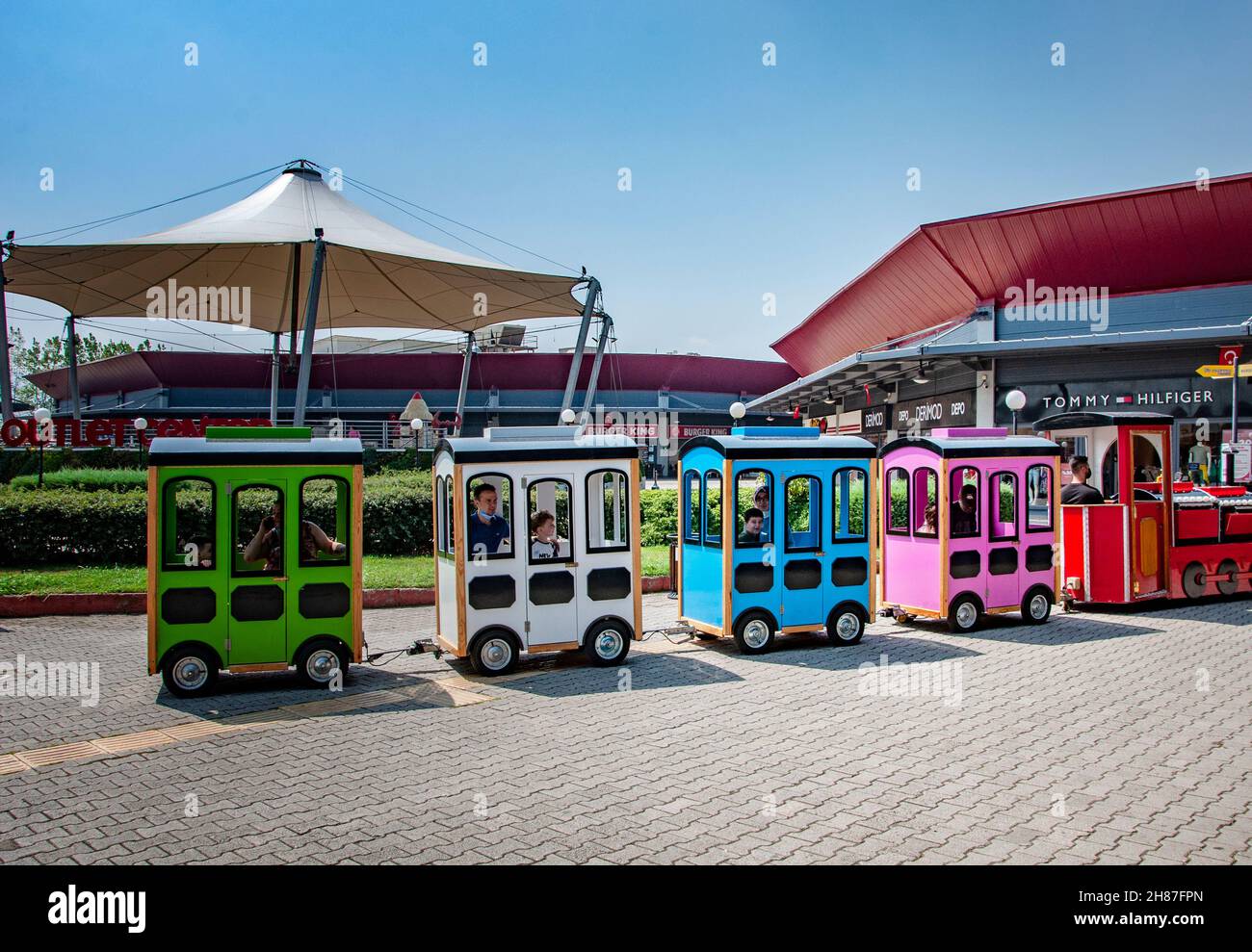 IZMIT, TURKEY. AUGUST 29, 2021. Outlet village Tommy Hilfiger shop on the background. Children attractions Stock Photo