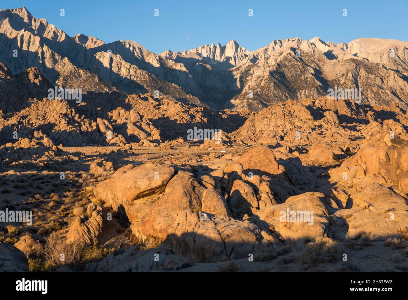 Alabama Hills National Scenic Area, Lone Pine, California, USA. View across rocky desert landscape to Mount Whitney and the Sierra Nevada, sunrise. Stock Photo