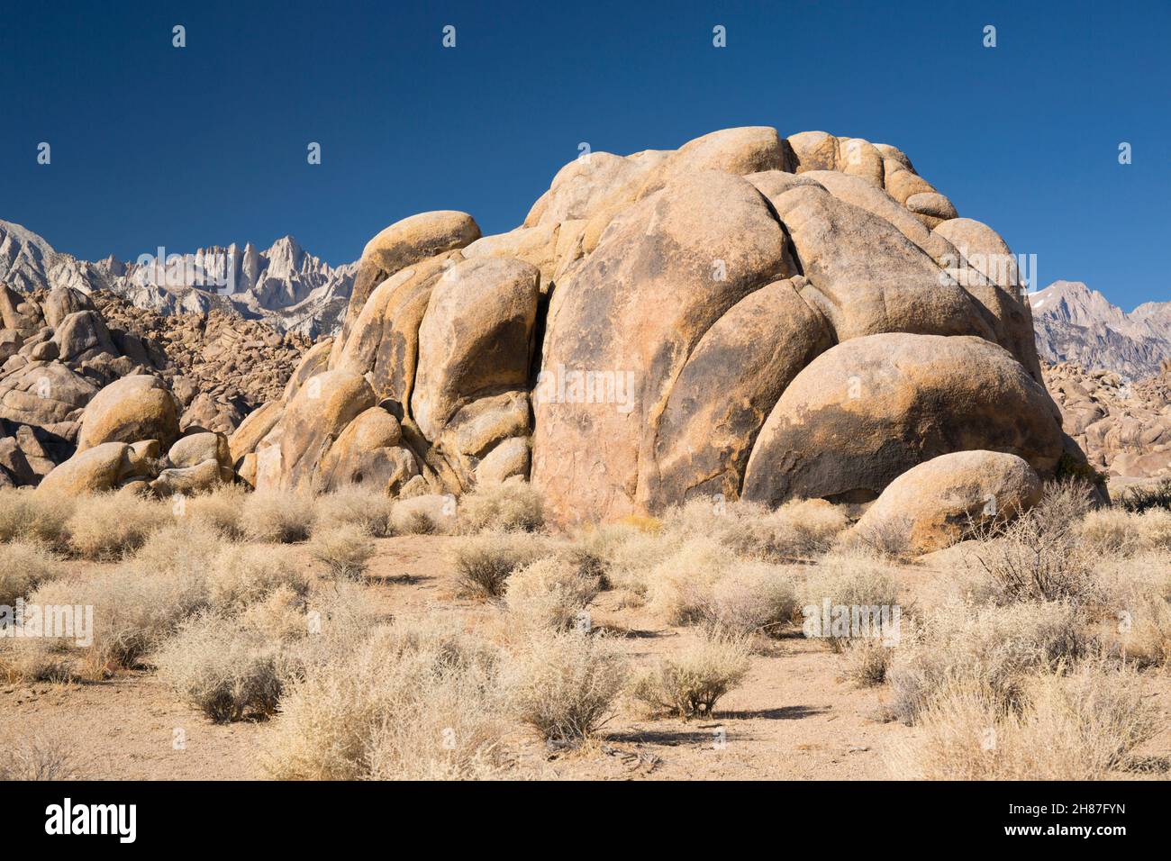 Alabama Hills National Scenic Area, Lone Pine, California, USA. Huge granite boulders in arid desert landscape, Mount Whitney visible in background. Stock Photo