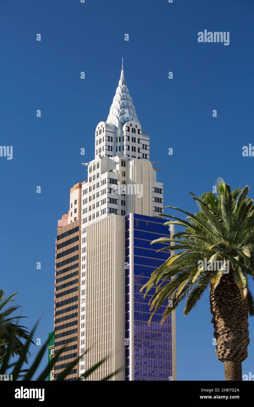 Las Vegas, Nevada, USA. Replica of the art deco Chrysler Building towering above palm trees at the New York-New York Hotel and Casino. Stock Photo