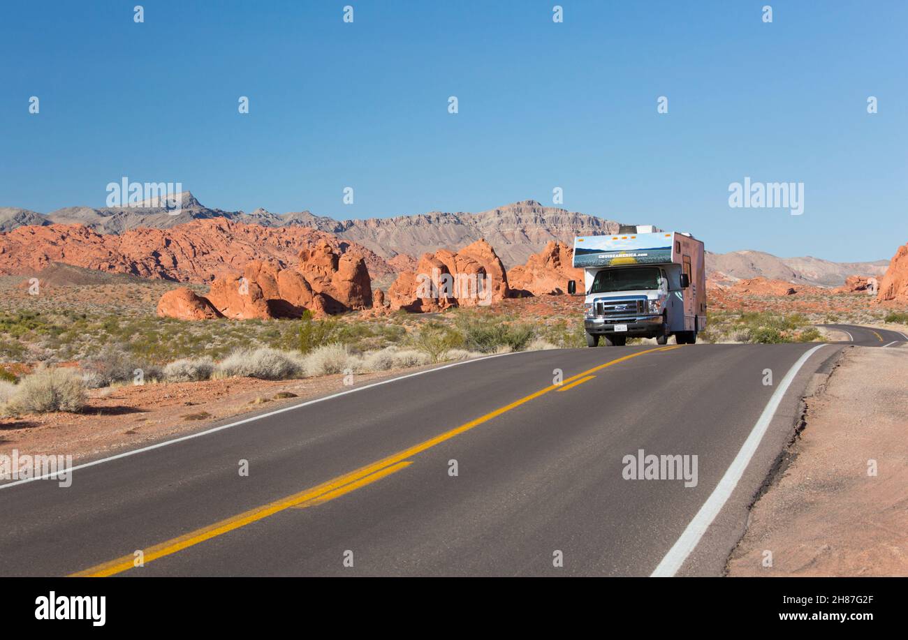 Valley of Fire State Park, Nevada, USA. Typical motorhome passing in front of the Seven Sisters, the Muddy Mountains in background. Stock Photo