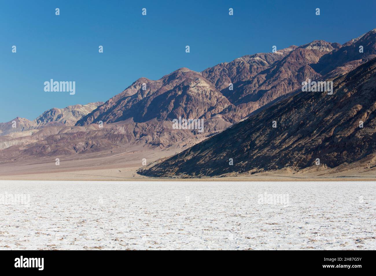 Death Valley National Park, California, USA. View across the vast expanse of salt flats at Badwater Basin to the western slopes of the Amargosa Range. Stock Photo