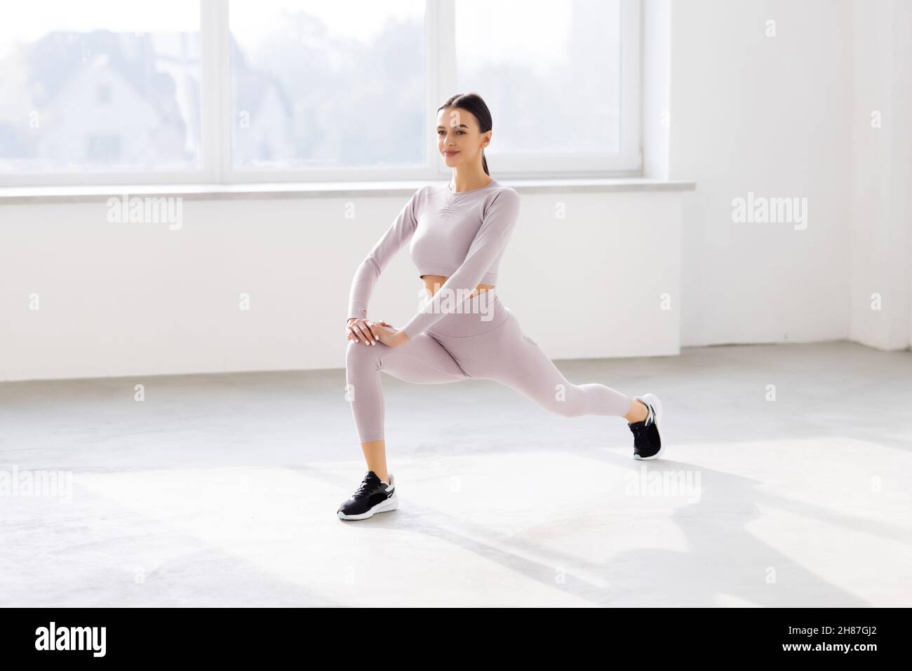 Fitness woman doing lunges exercises for leg muscle workout training ...