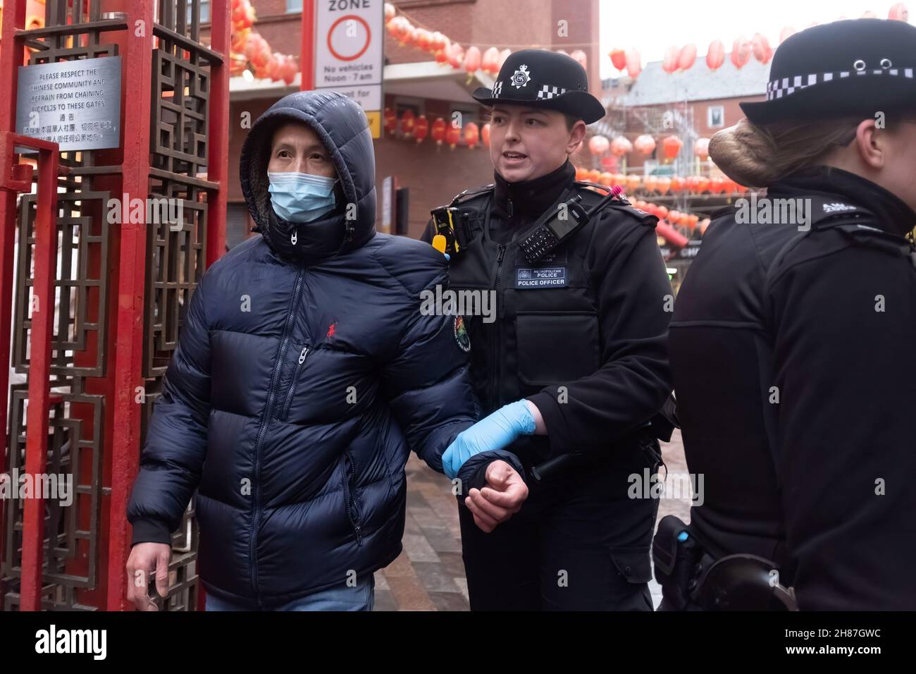 London, UK. 27th Nov, 2021. Police taking away an attendee from Pro-Beijing during the rally.'Anti-Asian Hate' rally organized by Pro-Beijing protesters and 'Lunch with you' rally organized by Hong Kong democracy protesters, separately gather at the same spot in Chinatown in London. While Pro-Beijing group shouting No Anti-Asian Hate, Hongkongers came back with Resist Chinese Communist Party (CCP) and No to Genocide. Credit: SOPA Images Limited/Alamy Live News Stock Photo