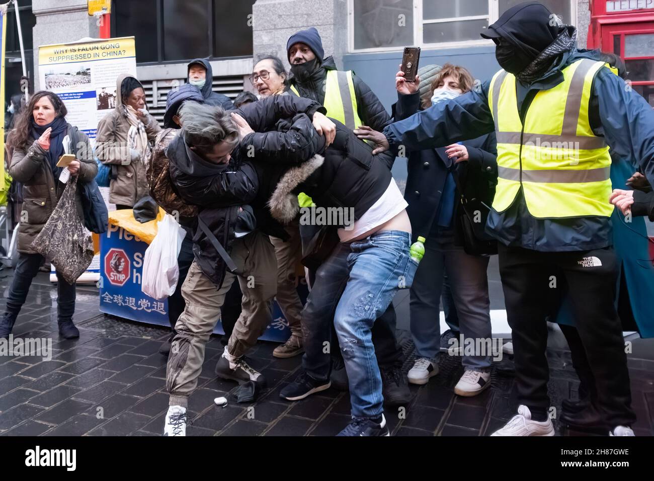 London, UK. 27th Nov, 2021. Scuffle between Pro-Beijing attendees and Hong Kong democracy protesters during the rally.'Anti-Asian Hate' rally organized by Pro-Beijing protesters and 'Lunch with you' rally organized by Hong Kong democracy protesters, separately gather at the same spot in Chinatown in London. While Pro-Beijing group shouting No Anti-Asian Hate, Hongkongers came back with Resist Chinese Communist Party (CCP) and No to Genocide. Credit: SOPA Images Limited/Alamy Live News Stock Photo