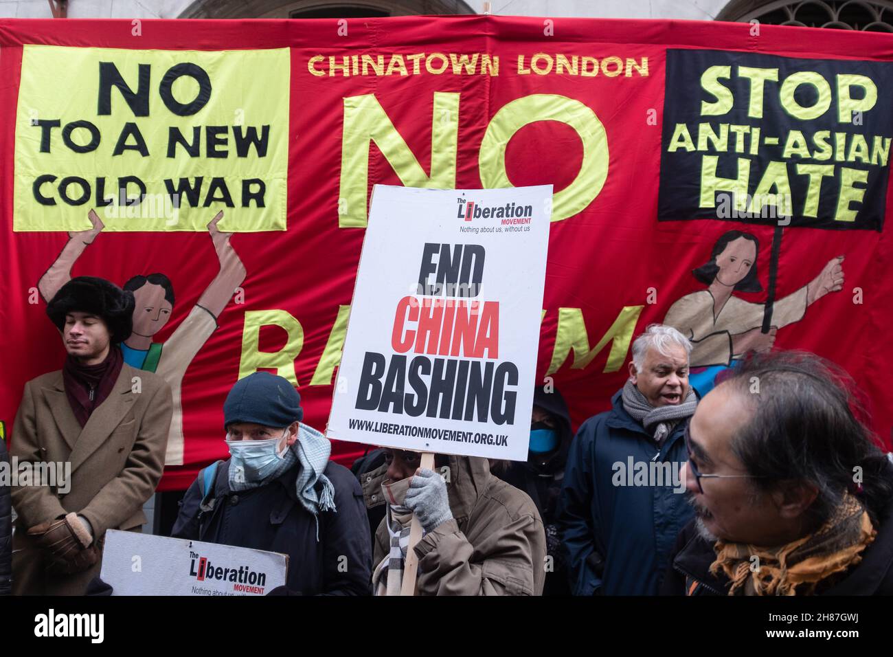 London, UK. 27th Nov, 2021. Pro-Beijing attendees hold placards expressing their opinion next to a banner during the rally.'Anti-Asian Hate' rally organized by Pro-Beijing protesters and 'Lunch with you' rally organized by Hong Kong democracy protesters, separately gather at the same spot in Chinatown in London. While Pro-Beijing group shouting No Anti-Asian Hate, Hongkongers came back with Resist Chinese Communist Party (CCP) and No to Genocide. Credit: SOPA Images Limited/Alamy Live News Stock Photo