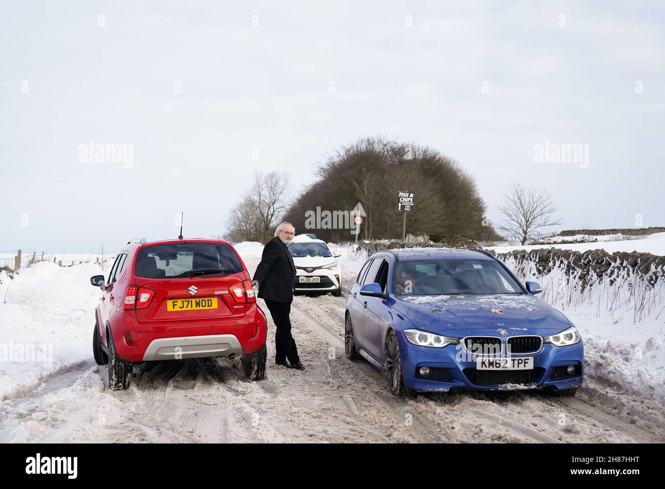 Vehicles attempt to travel along the snow-covered A515 near Biggin, in the Peak District, Derbyshire, amid freezing conditions in the aftermath of Storm Arwen. Picture date: Sunday November 28, 2021. Stock Photo